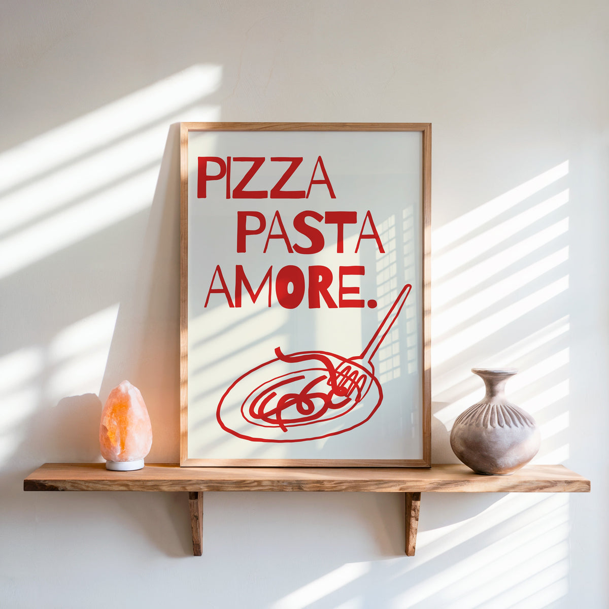 Pizza Pasta Amore print in an oak frame on a live-edge shelf beside a salt lamp