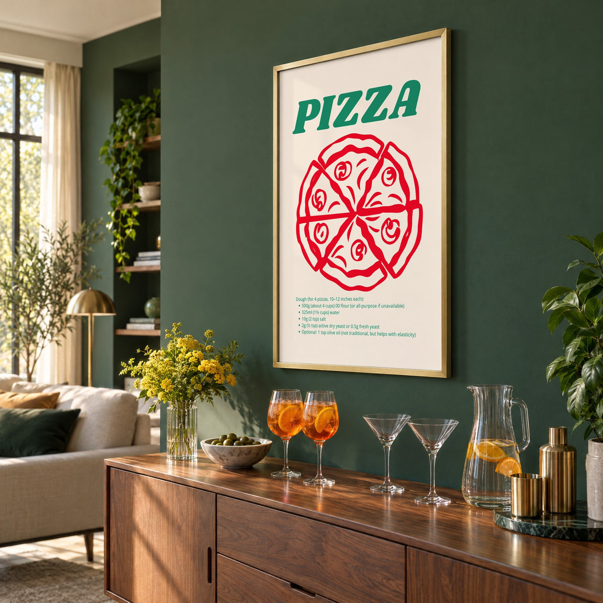 PIZZA dough recipe red line pizza print in a brass frame on a bottle green wall above a sideboard with spritz and martini glasses, seen at an angle