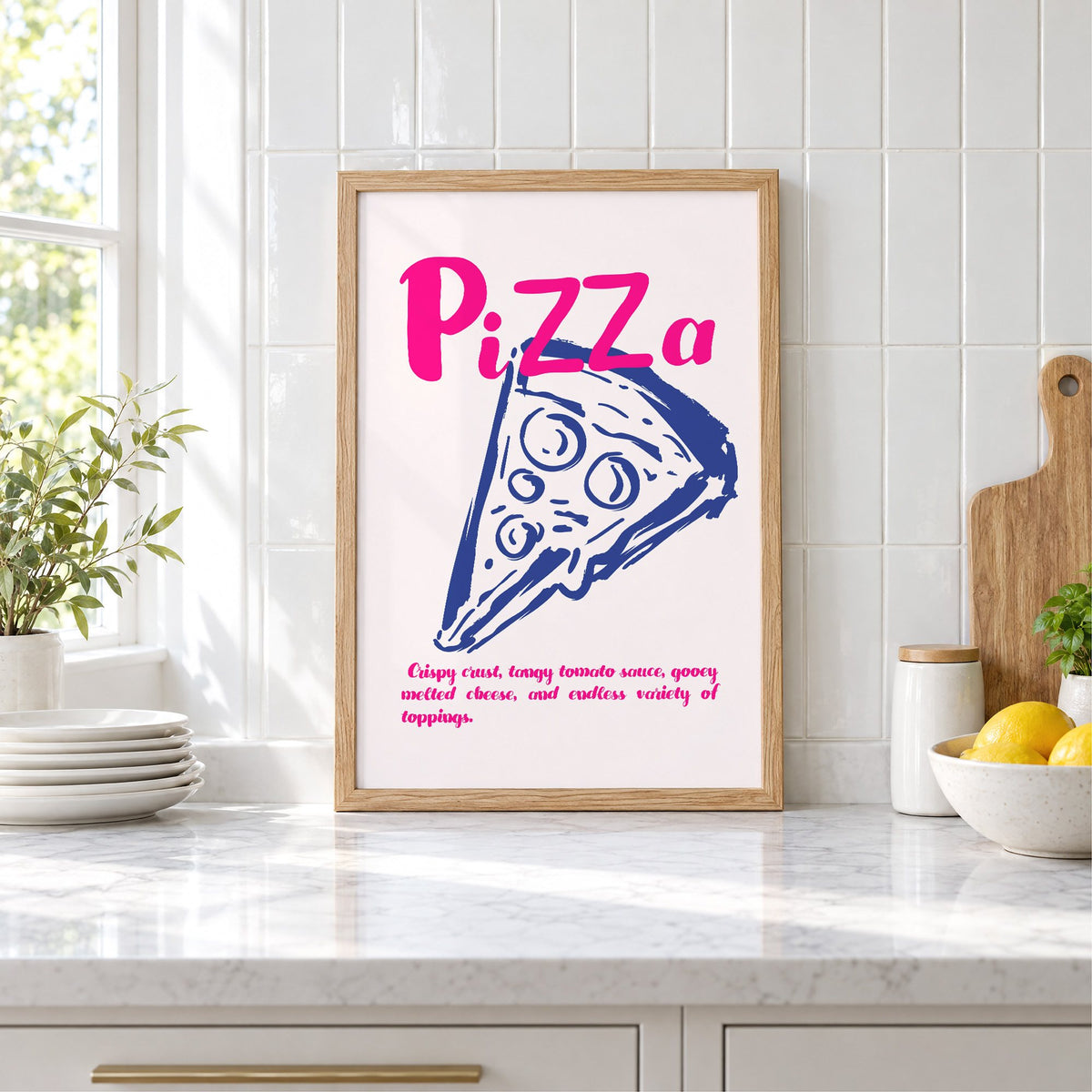 PiZZa pink script pizza slice print in an oak frame leaning on a marble counter by white tiles and lemons
