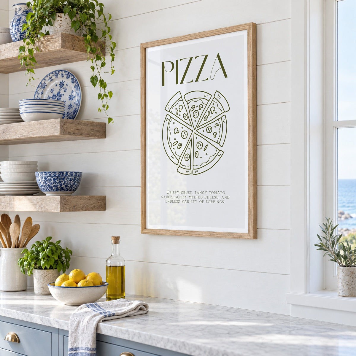 PIZZA olive line art print in an oak frame in a white coastal kitchen beside blue and white plates