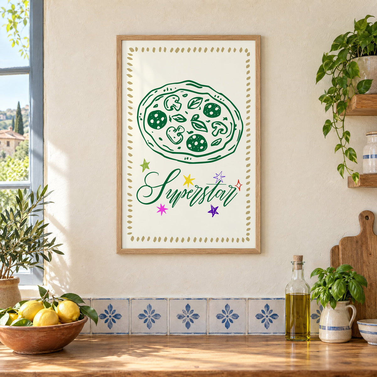 Superstar green pizza and stars print in an oak frame on a cream plaster wall above a worktop with a bowl of lemons and blue-and-white tiles