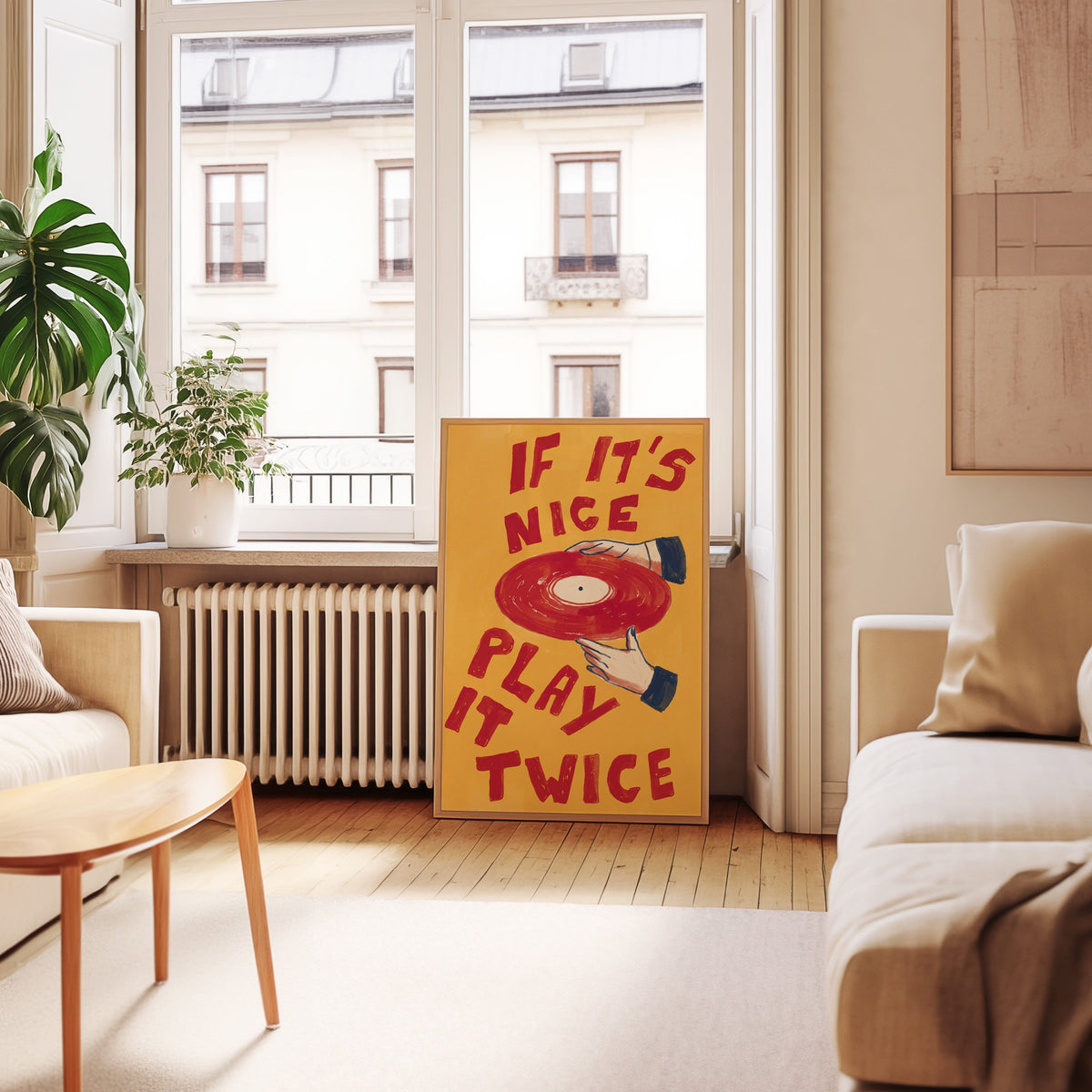 Hands holding red record print in an oak frame leaning below tall French windows