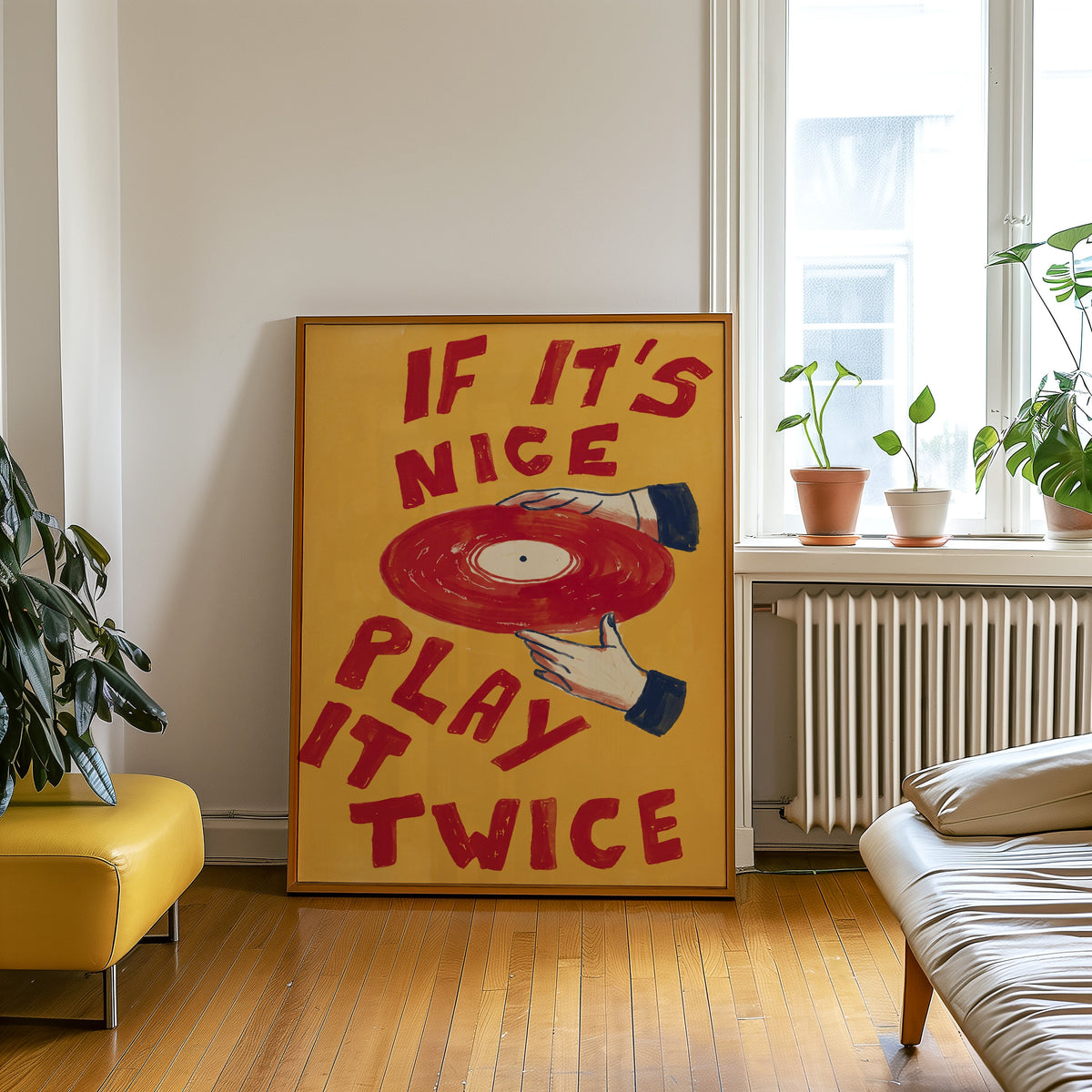 Record collector print in an oak frame leaning beside a yellow leather bench