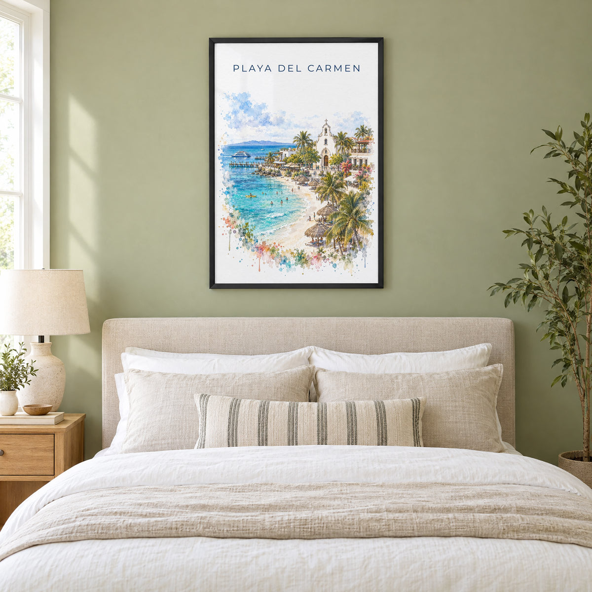 Playa del Carmen watercolor print in a black frame above an upholstered headboard in a sage green bedroom