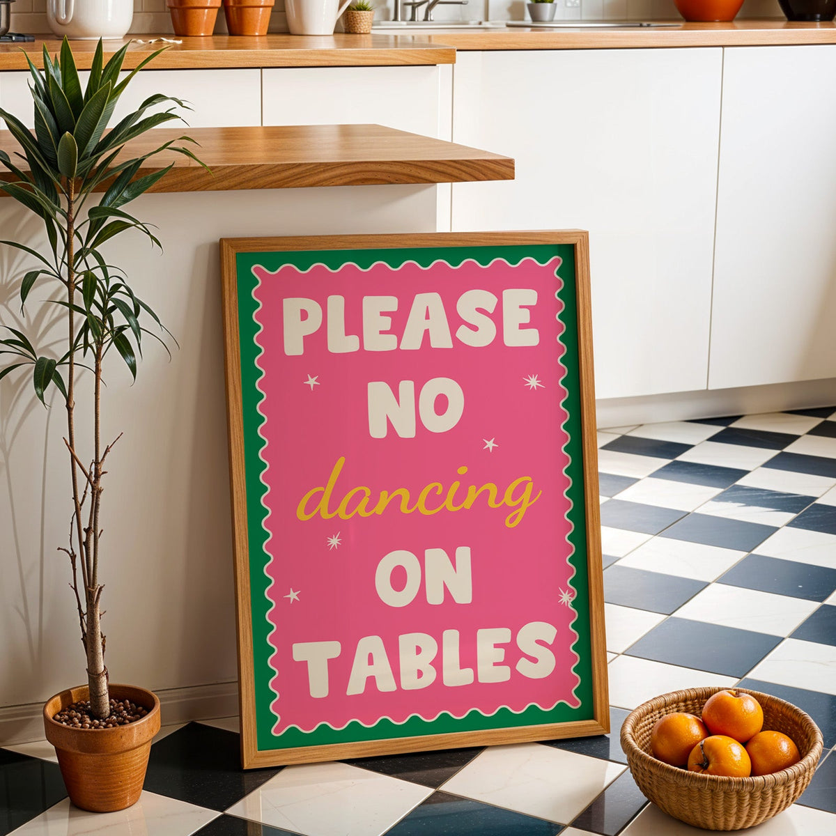 Please no dancing on tables print in an oak frame by a kitchen island and tiled floor