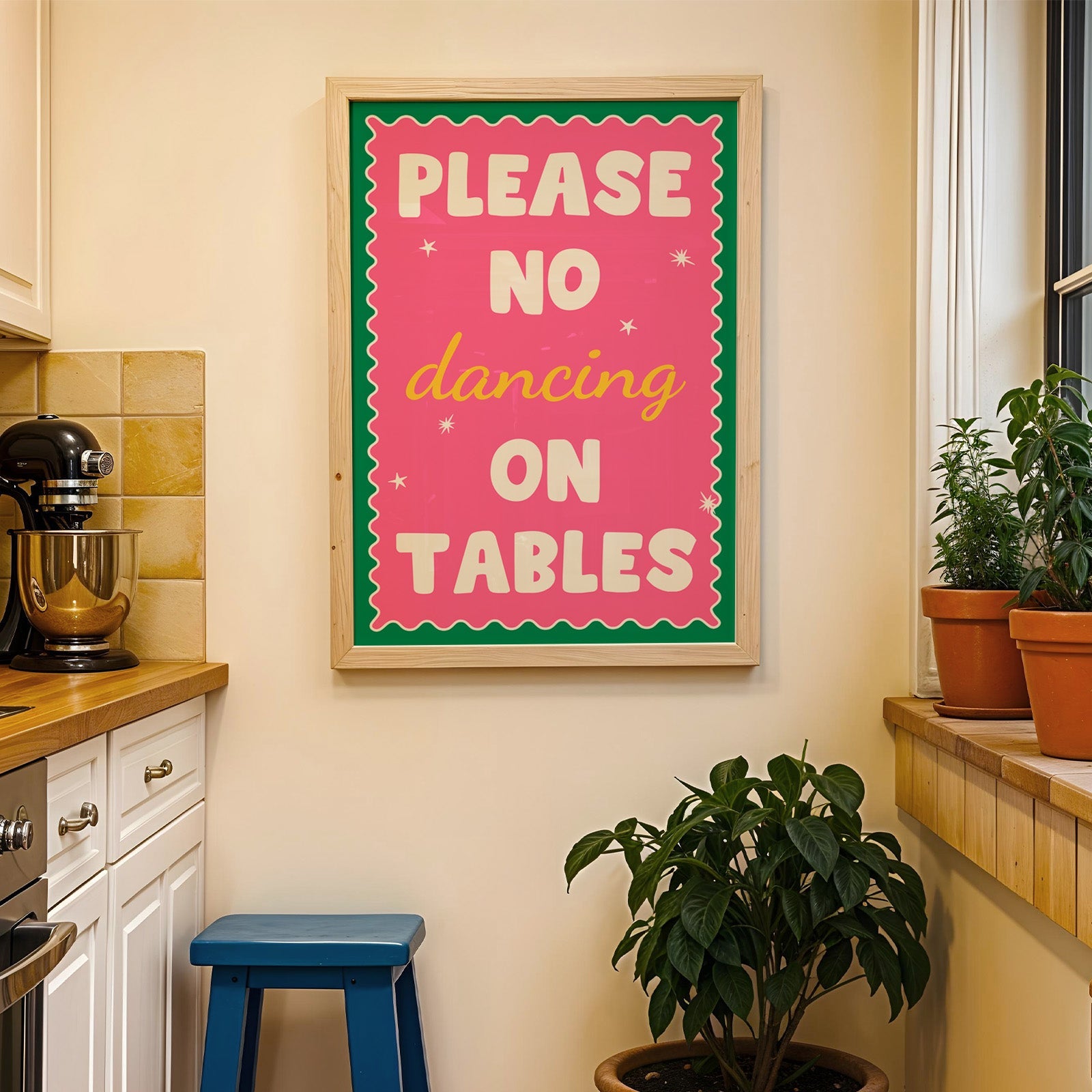 Please no dancing on tables print in a wood frame on a yellow tiled kitchen wall