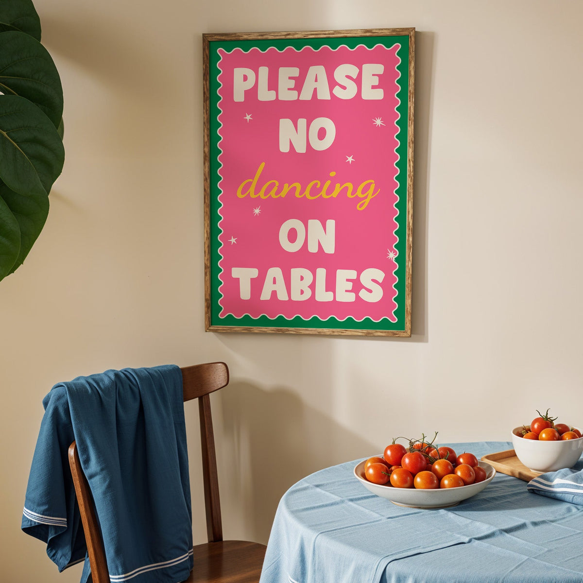 Please no dancing on tables print in an oak frame above a blue linen table