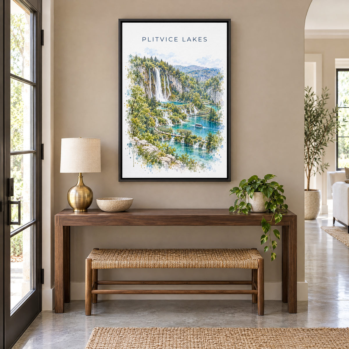 Plitvice Lakes watercolor print as a black floater canvas above a walnut console and woven bench in an entryway