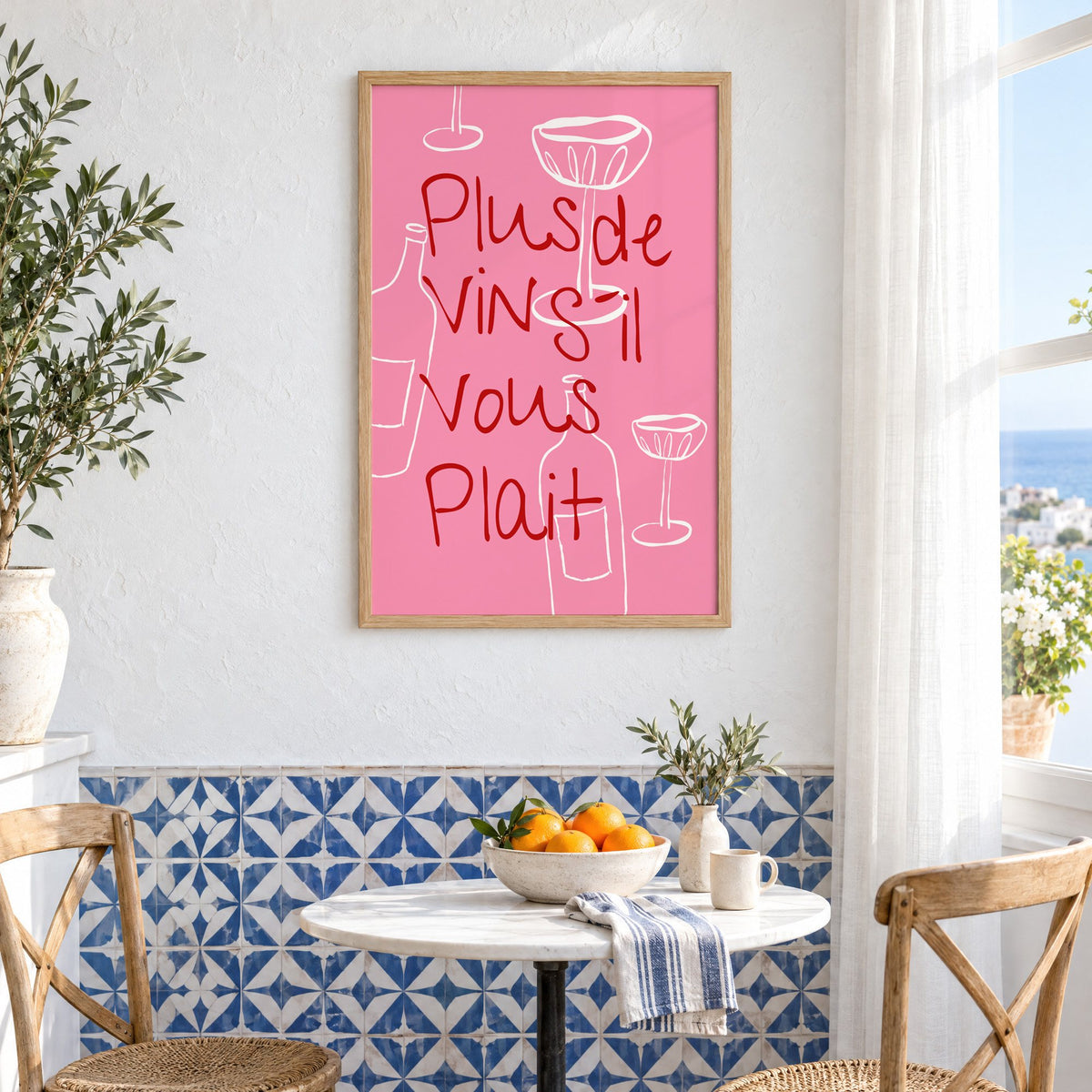 Plus de Vin handwritten pink print in an oak frame above a bistro table and blue patterned tiles