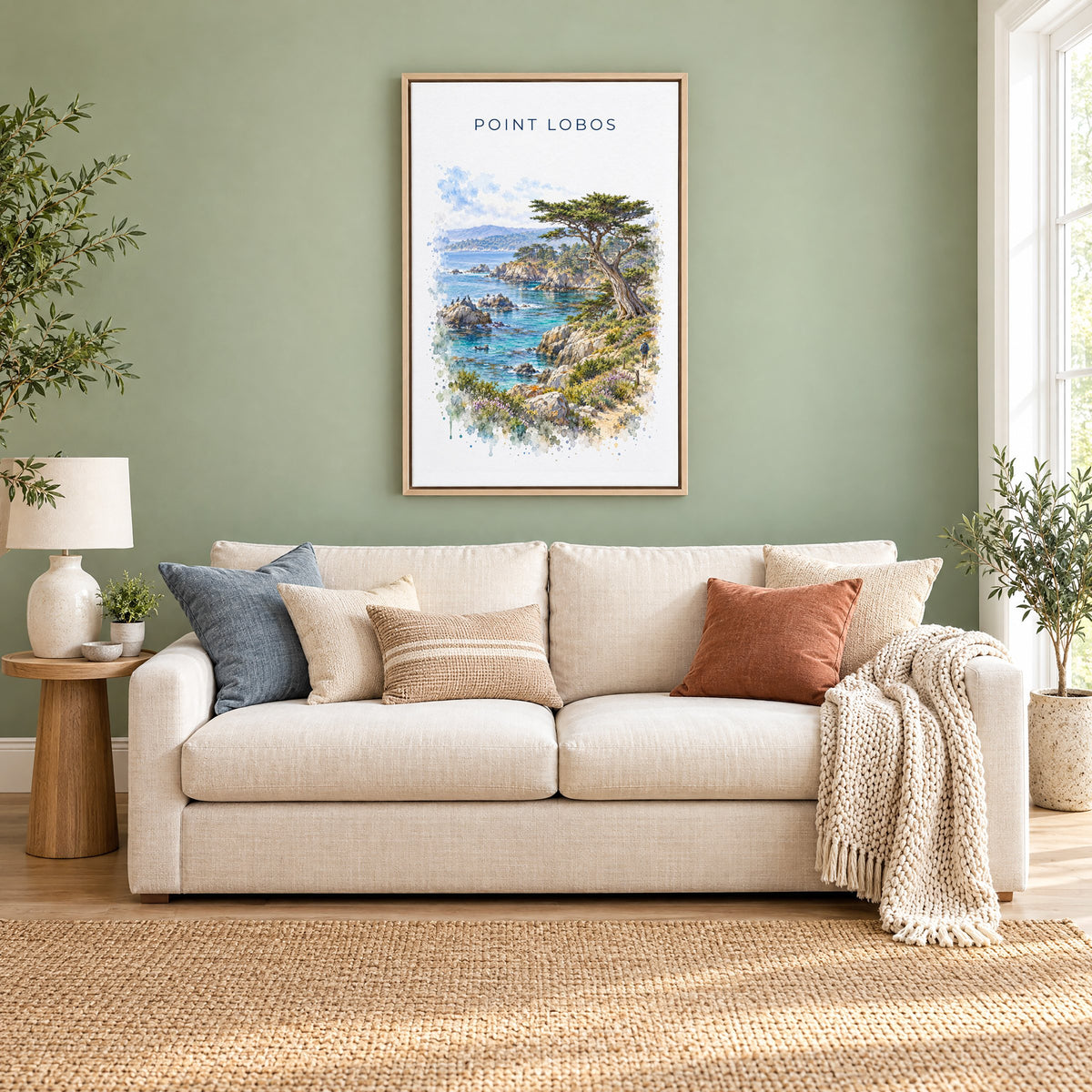 Point Lobos State Natural Reserve watercolor print as a natural floater canvas above a cream linen sofa on a sage green wall