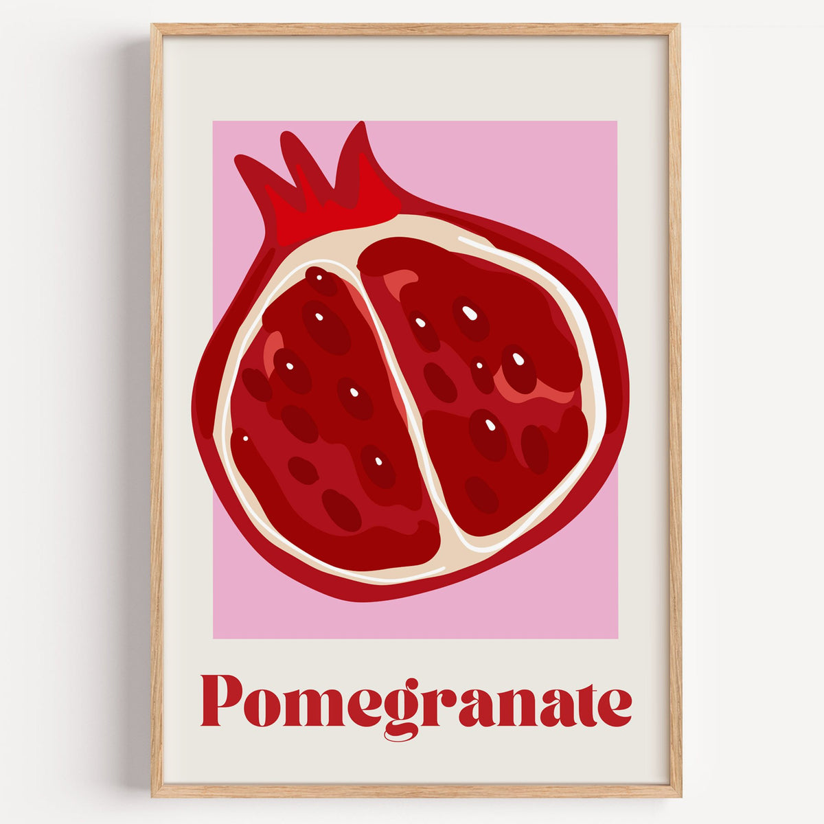 Pomegranate half bold serif pink panel print in a light oak frame on a plain white wall