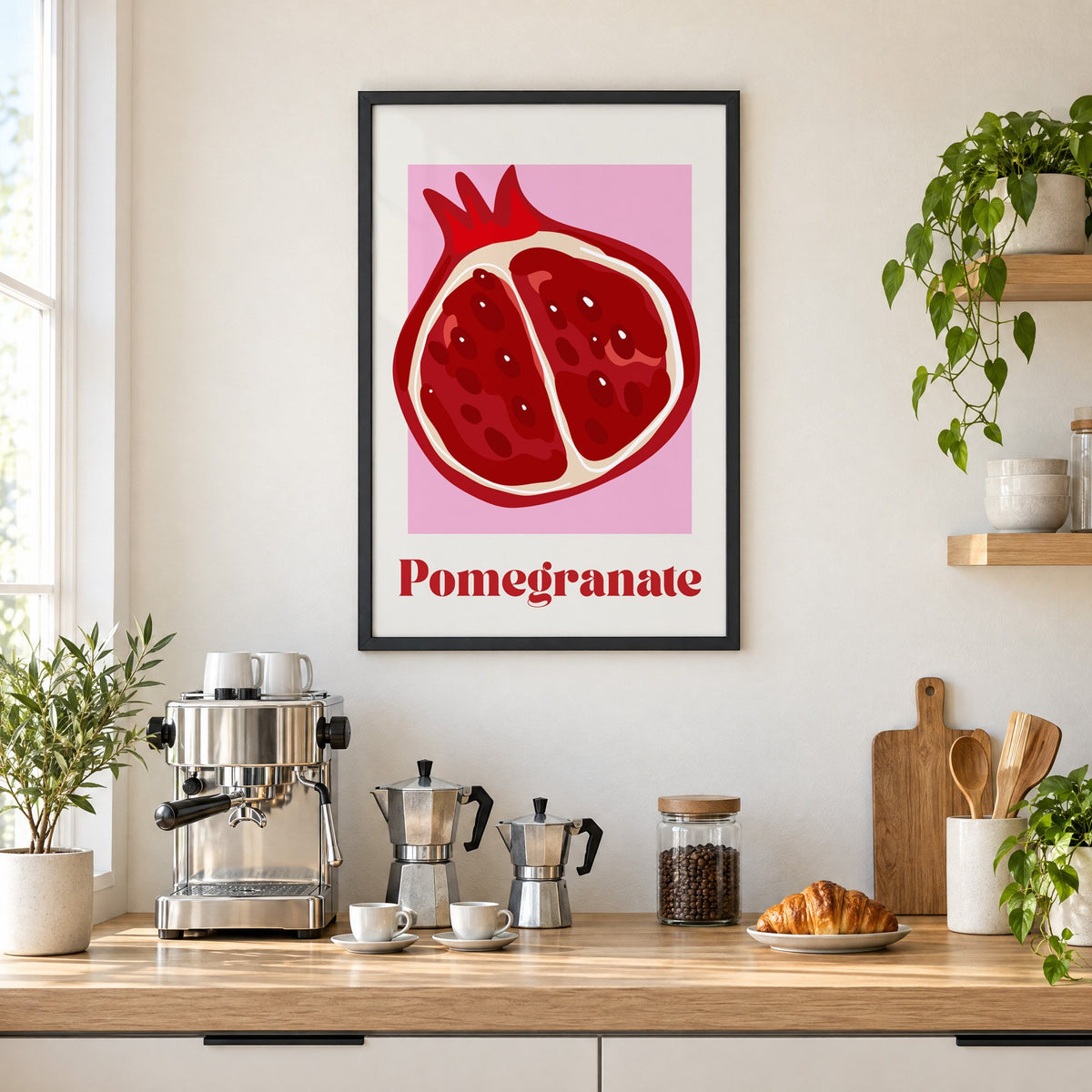 Pomegranate half bold serif pink panel print in a black frame above a home espresso bar with moka pots and espresso cups