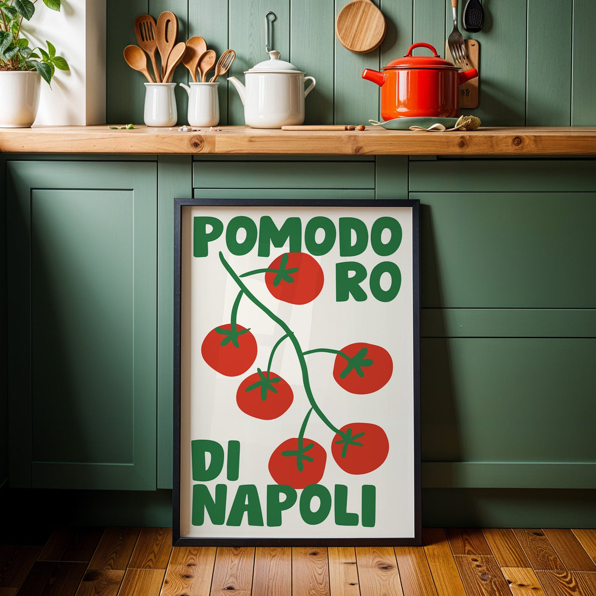 Pomodoro di Napoli tomato print in a black frame against sage green kitchen cabinets