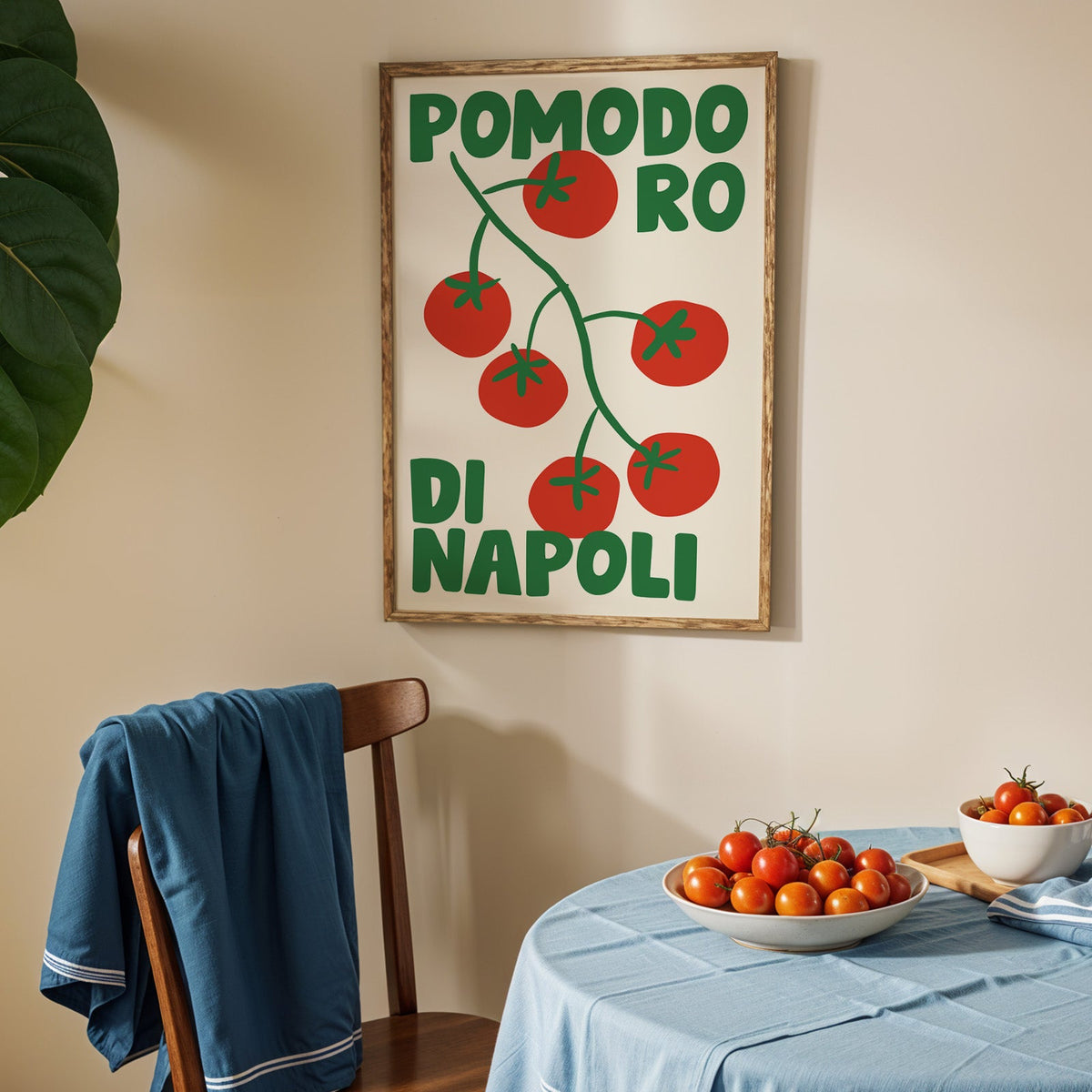 Pomodoro di Napoli tomato print in an oak frame above a blue linen table with tomatoes