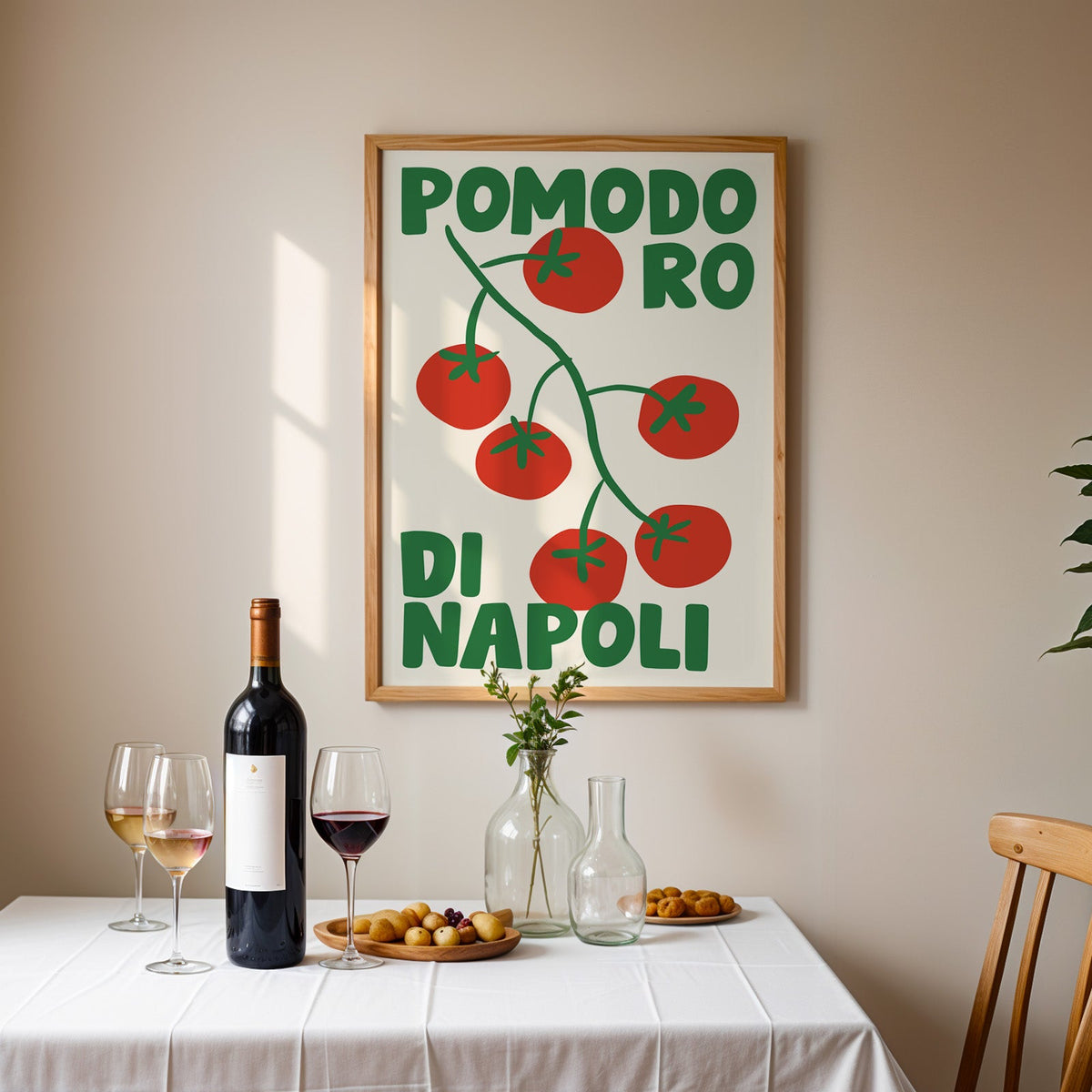 Pomodoro di Napoli tomato print in an oak frame above a table laid with red wine