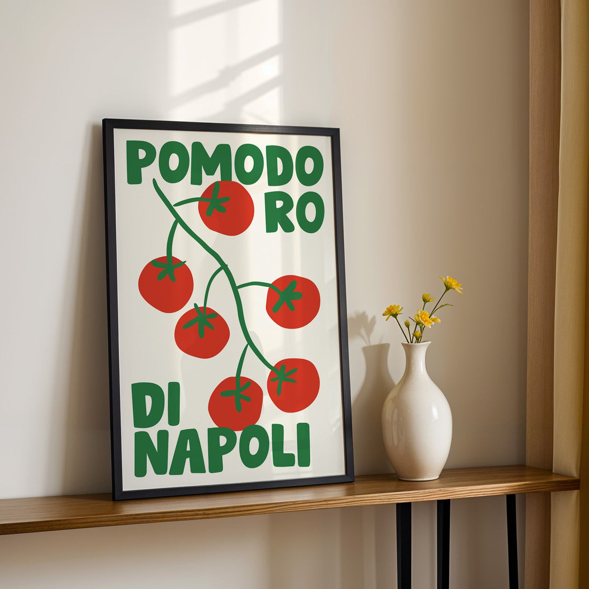 Pomodoro di Napoli tomato print in a black frame on a console table with daisies
