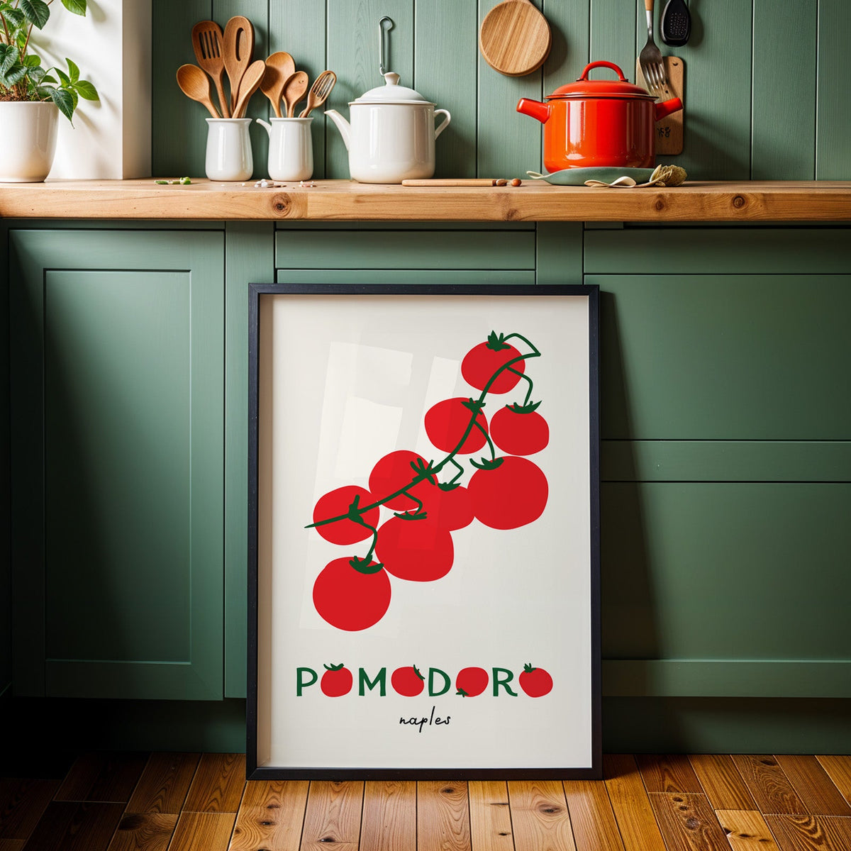 Pomodoro Naples tomato vine print in a black frame against sage green kitchen cabinets