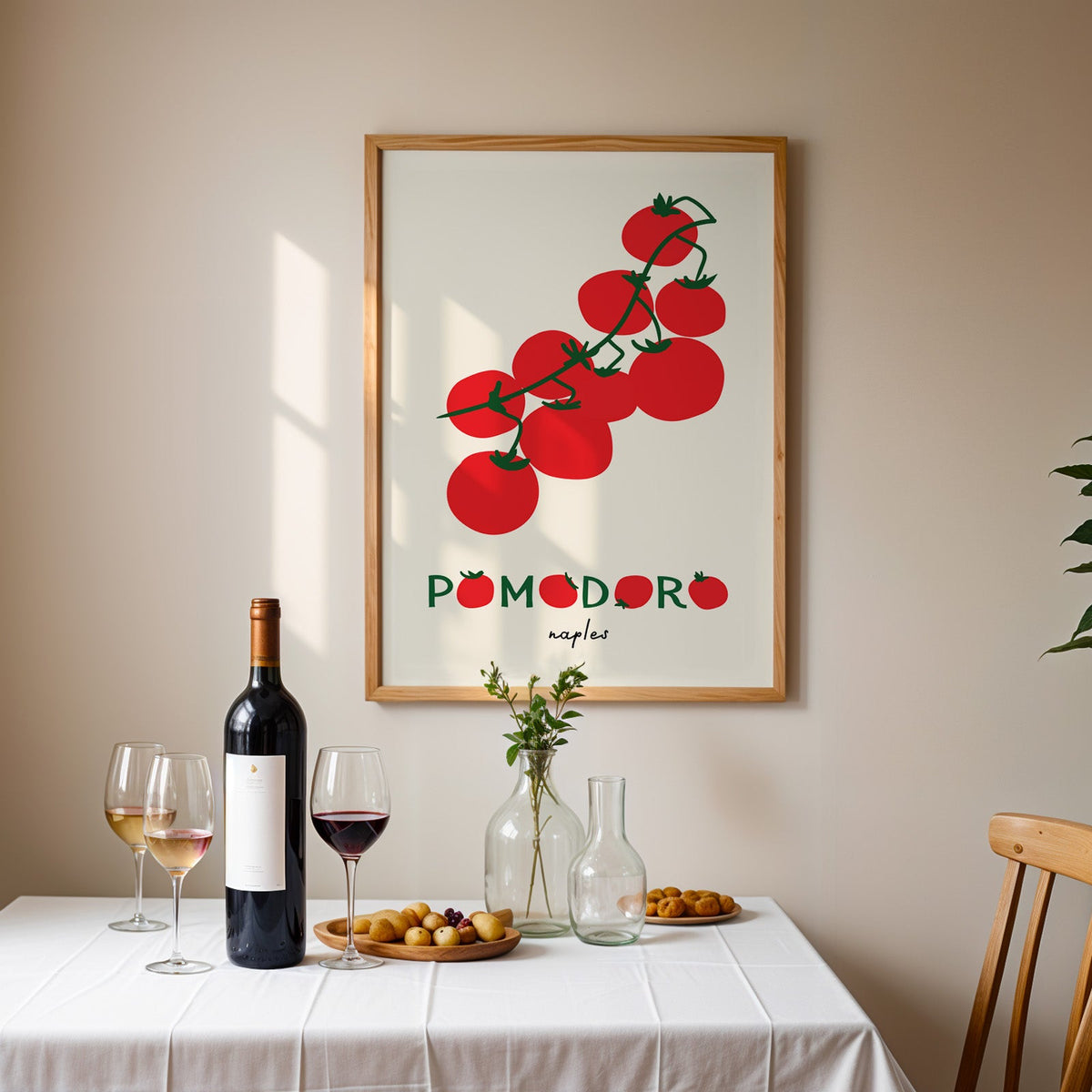 Pomodoro Naples tomato vine print in an oak frame above a table laid with red wine