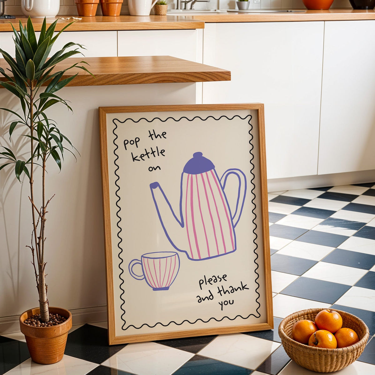 Pop the kettle on teapot print in an oak frame by a kitchen island and tiled floor