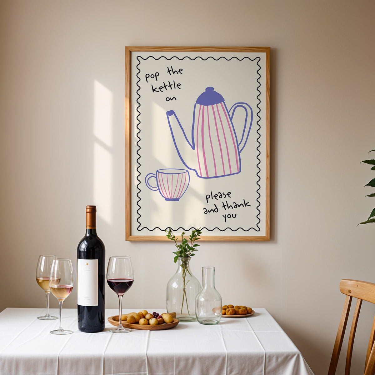 Pop the kettle on teapot print in an oak frame above a table laid with red wine