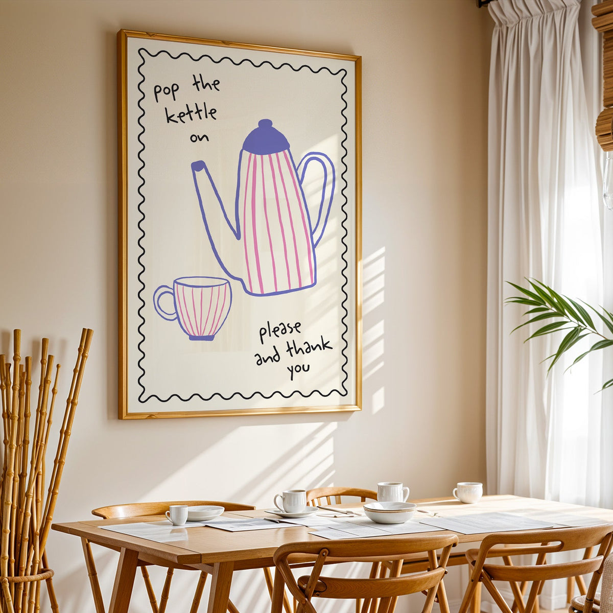 Pop the kettle on teapot print in a gold frame above a sunlit breakfast table