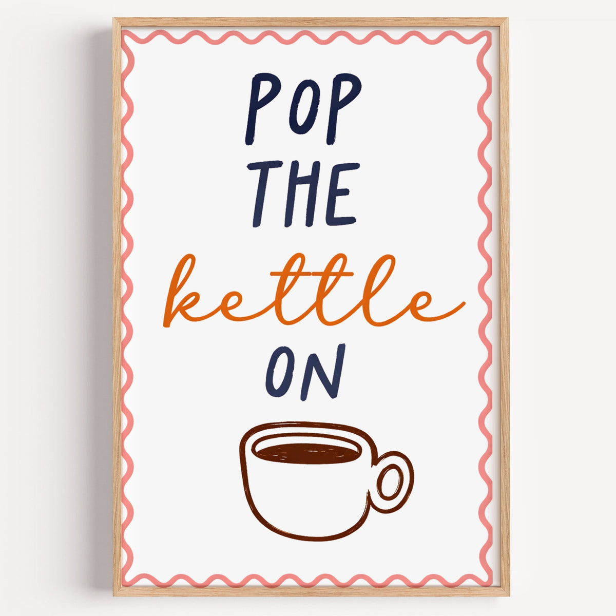 Pop the Kettle On tea print in a light oak frame on a plain white wall