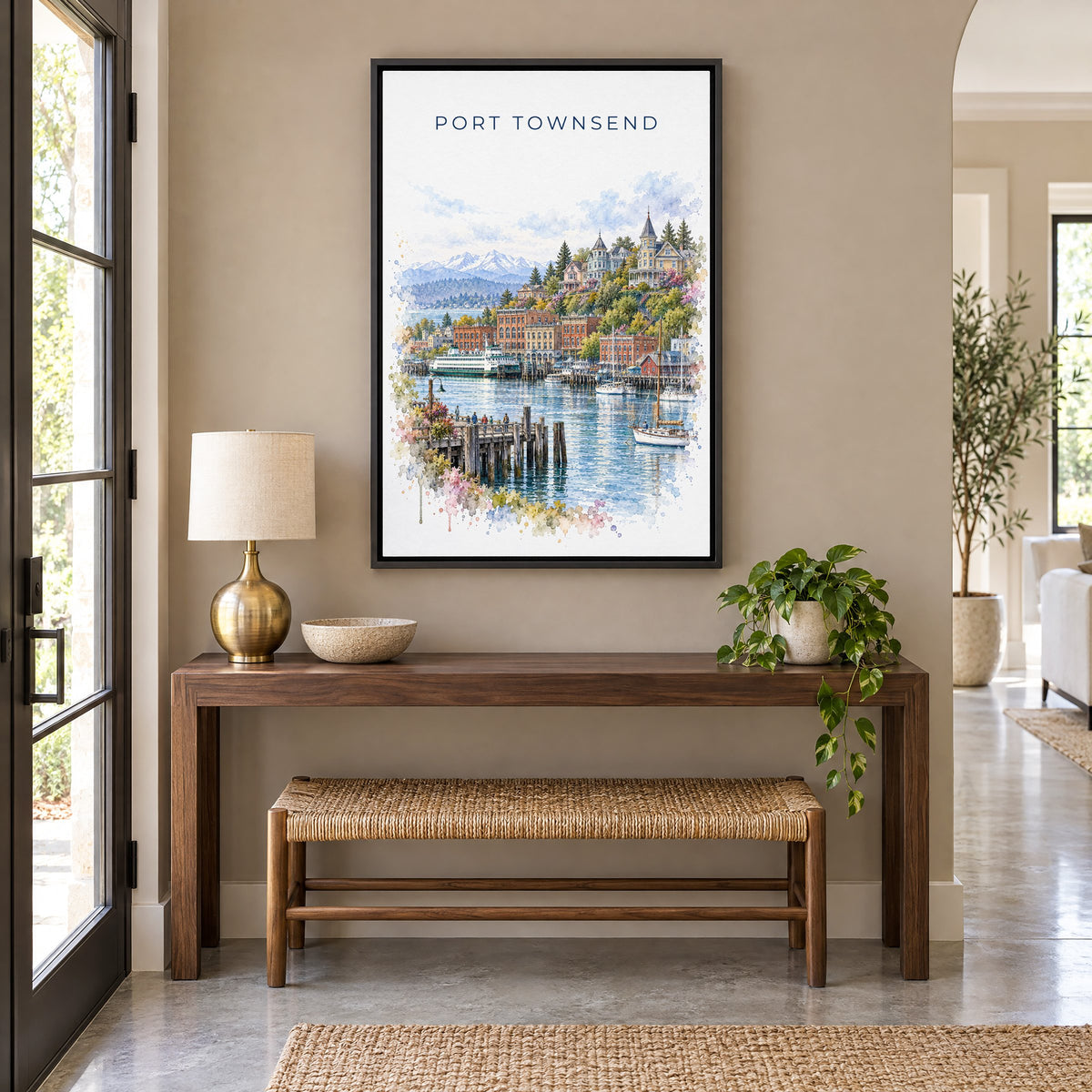 Port Townsend watercolor print as a black floater canvas above a walnut console and woven bench in an entryway