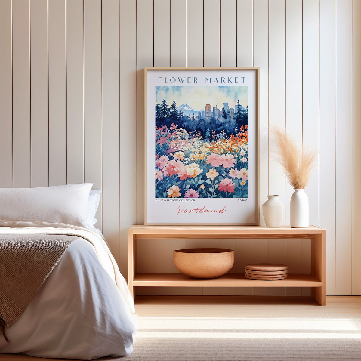 Portland flower market print in an oak frame on a wood bench against a white shiplap bedroom wall with pampas grass