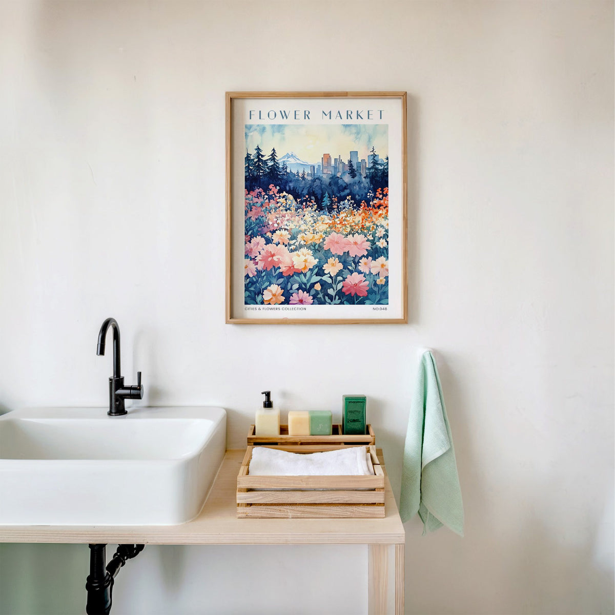 Portland flower market print in an oak frame above a white bathroom sink with folded towels