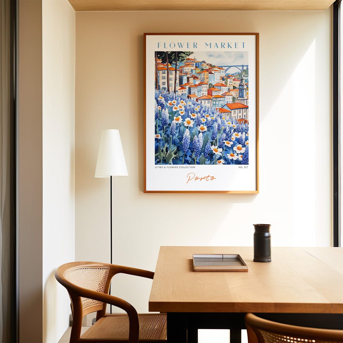 Porto flower market print in an oak frame above a dining table and cane chair