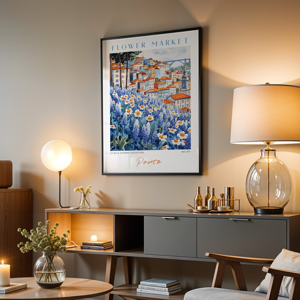 Porto flower market print in a black frame above a grey media console with a glass table lamp