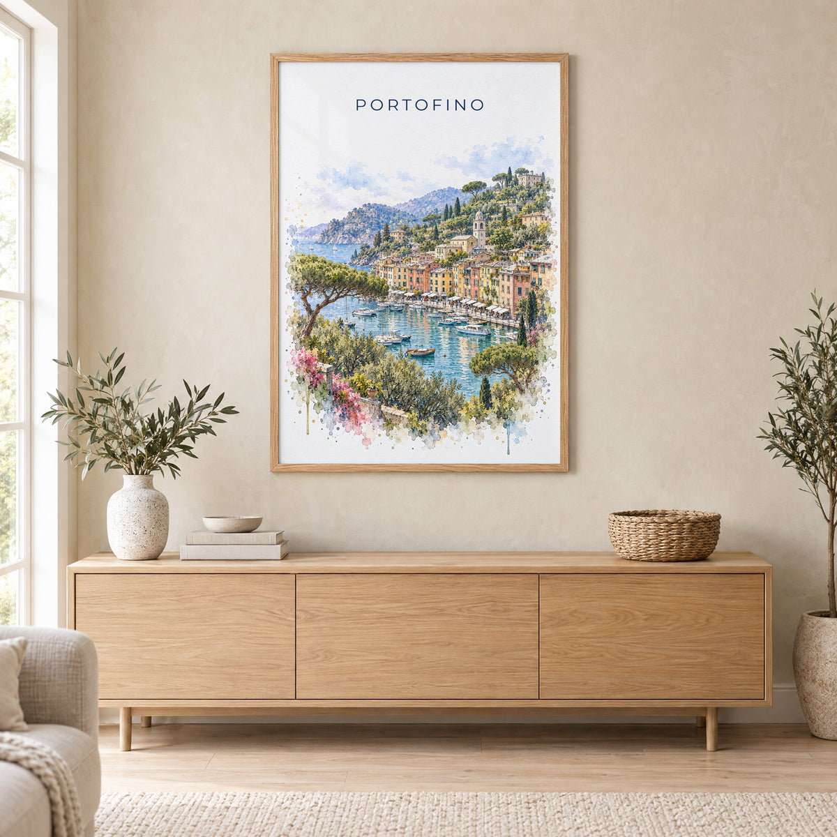 Portofino watercolor print in an oak frame above a light wood sideboard in a Scandinavian living room