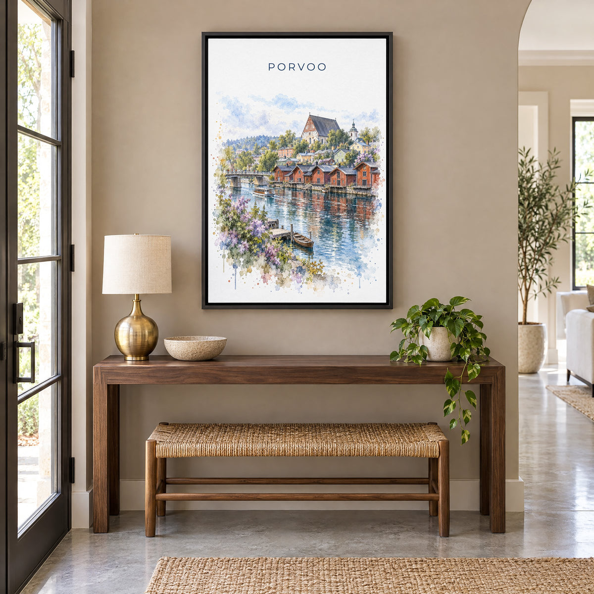 Porvoo watercolor print as a black floater canvas above a walnut console and woven bench in an entryway