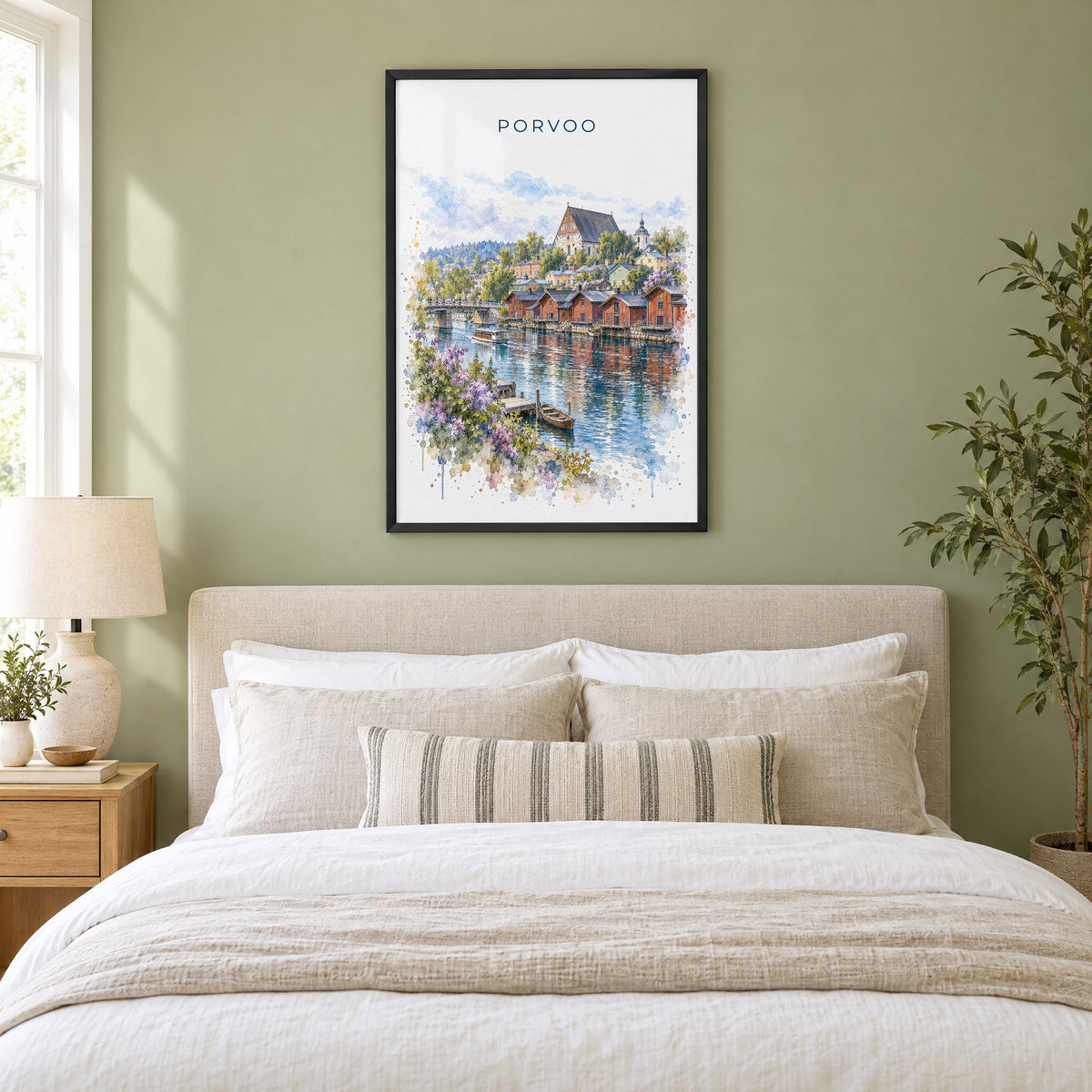Porvoo watercolor print in a black frame above an upholstered headboard in a sage green bedroom