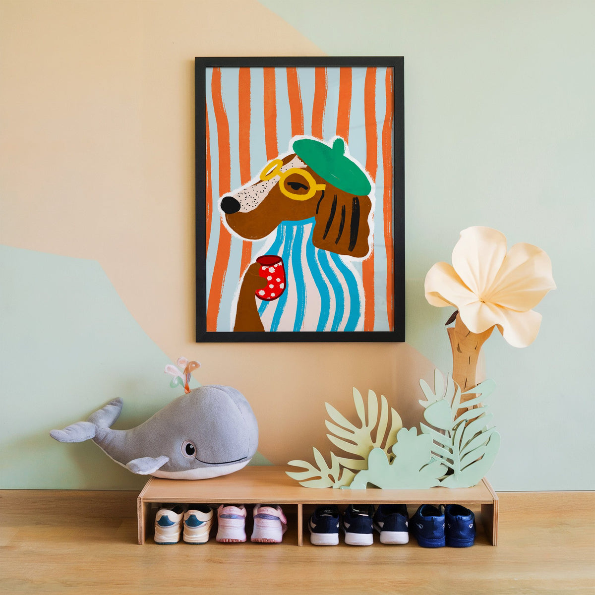 Posh dog in green beret nursery print in a black frame on a mint and peach wall above a whale plush