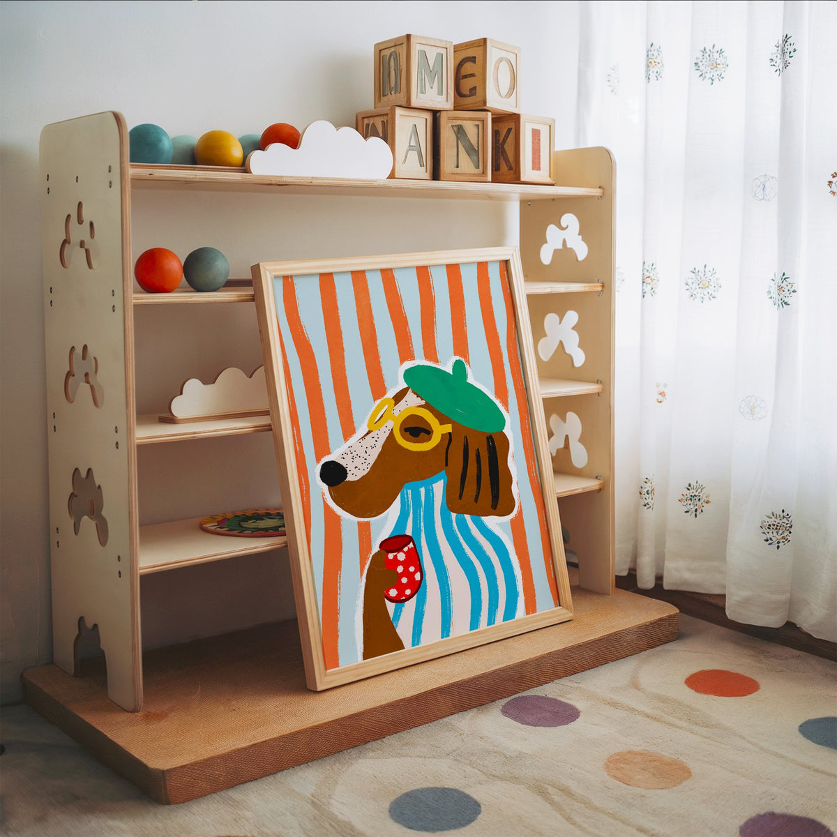 Posh dog in green beret nursery print in an oak frame leaning on a toy shelf with wooden letter blocks