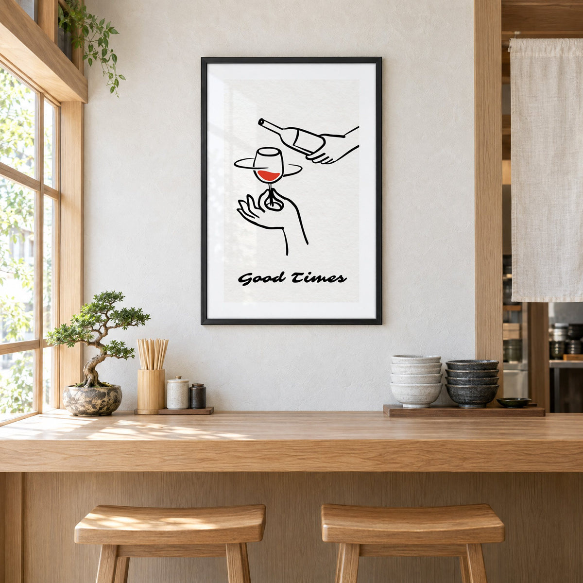 Good Times wine bottle and glass line print in a black frame above a light wood ramen counter with stools and stacked bowls