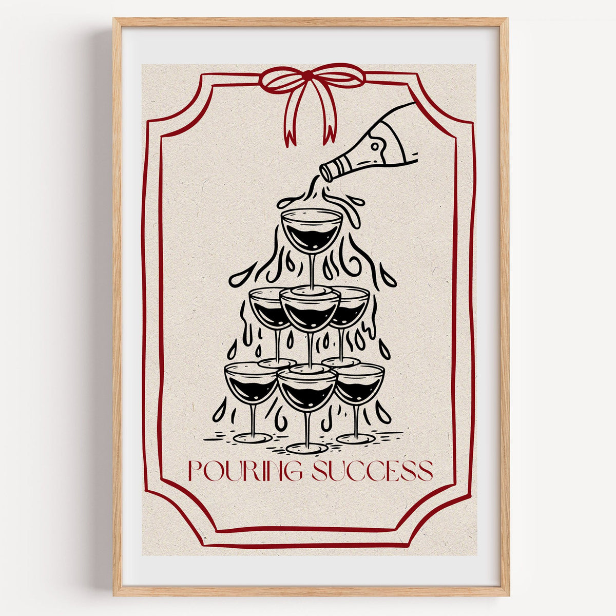 POURING SUCCESS champagne tower print in a light oak frame on a plain white wall