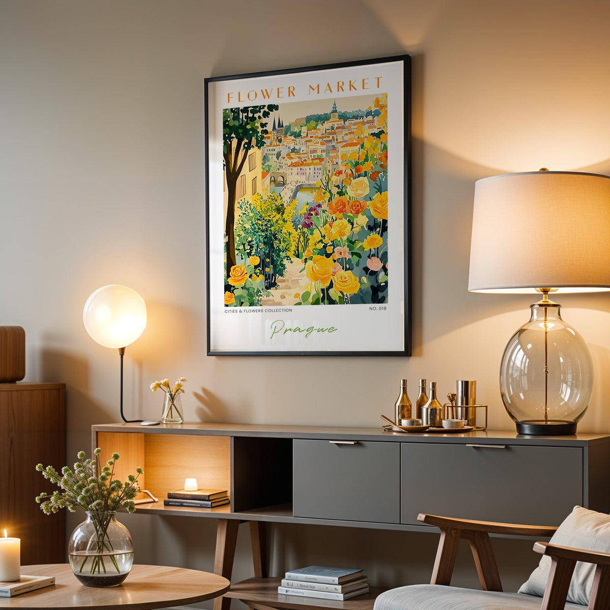 Prague flower market print in a black frame above a grey media console with a glass table lamp