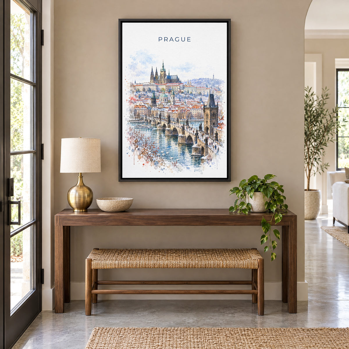 Prague watercolor print as a black floater canvas above a walnut console and woven bench in an entryway