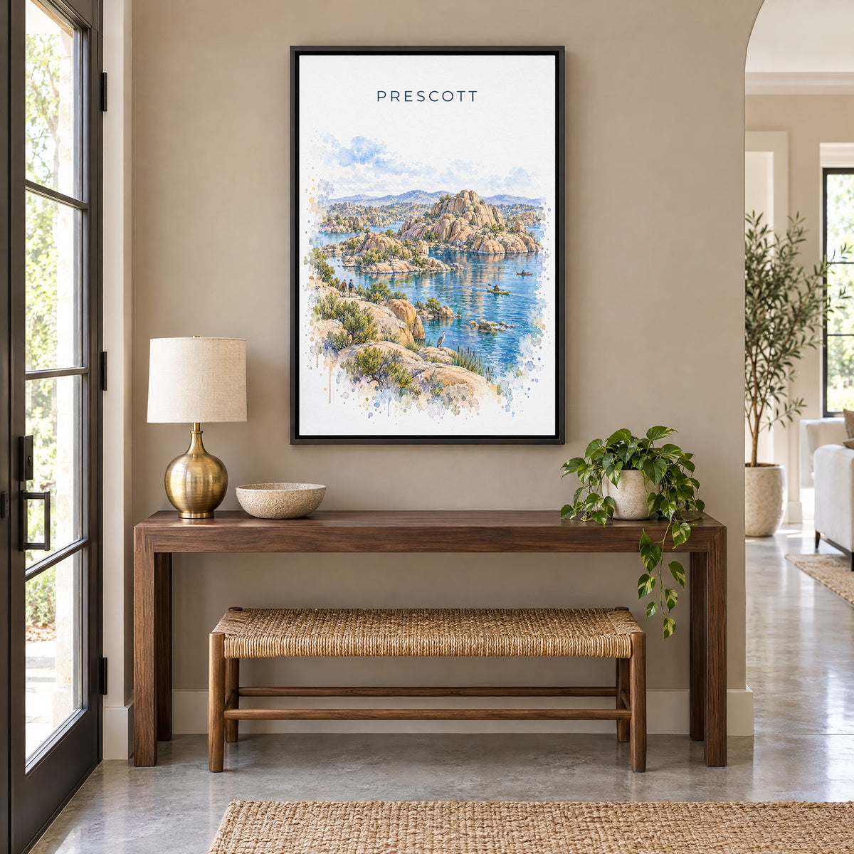 Prescott watercolor print as a black floater canvas above a walnut console and woven bench in an entryway