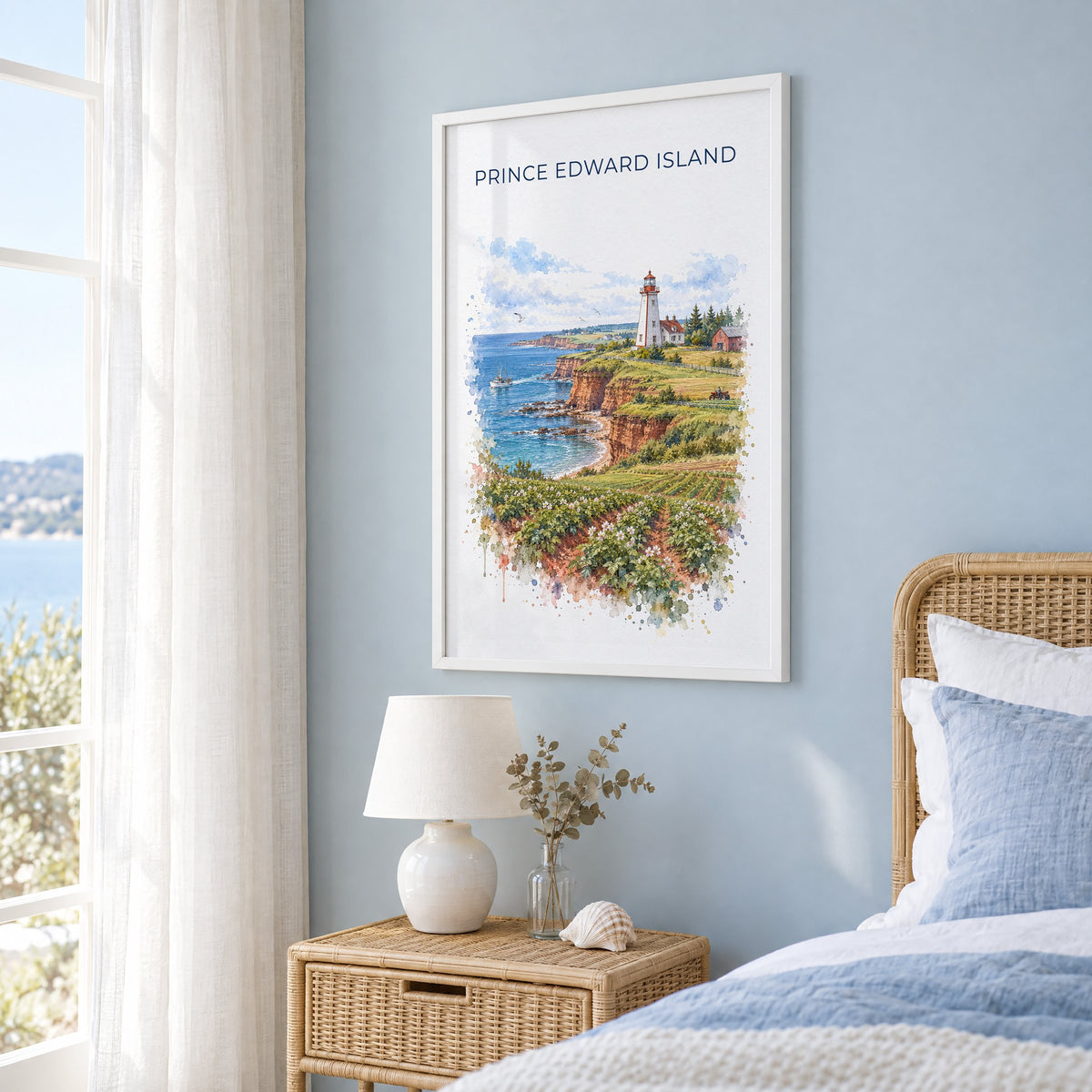 Prince Edward Island watercolor print in a white frame on a pale blue wall beside a rattan bed in a coastal bedroom