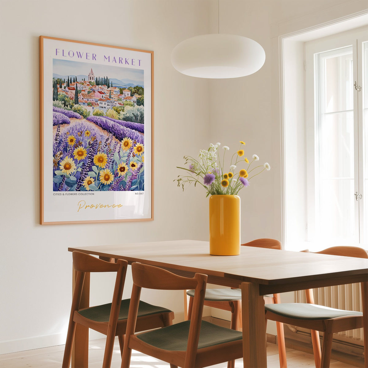 Provence flower market print in an oak frame above a dining table with a yellow vase and white pendant light