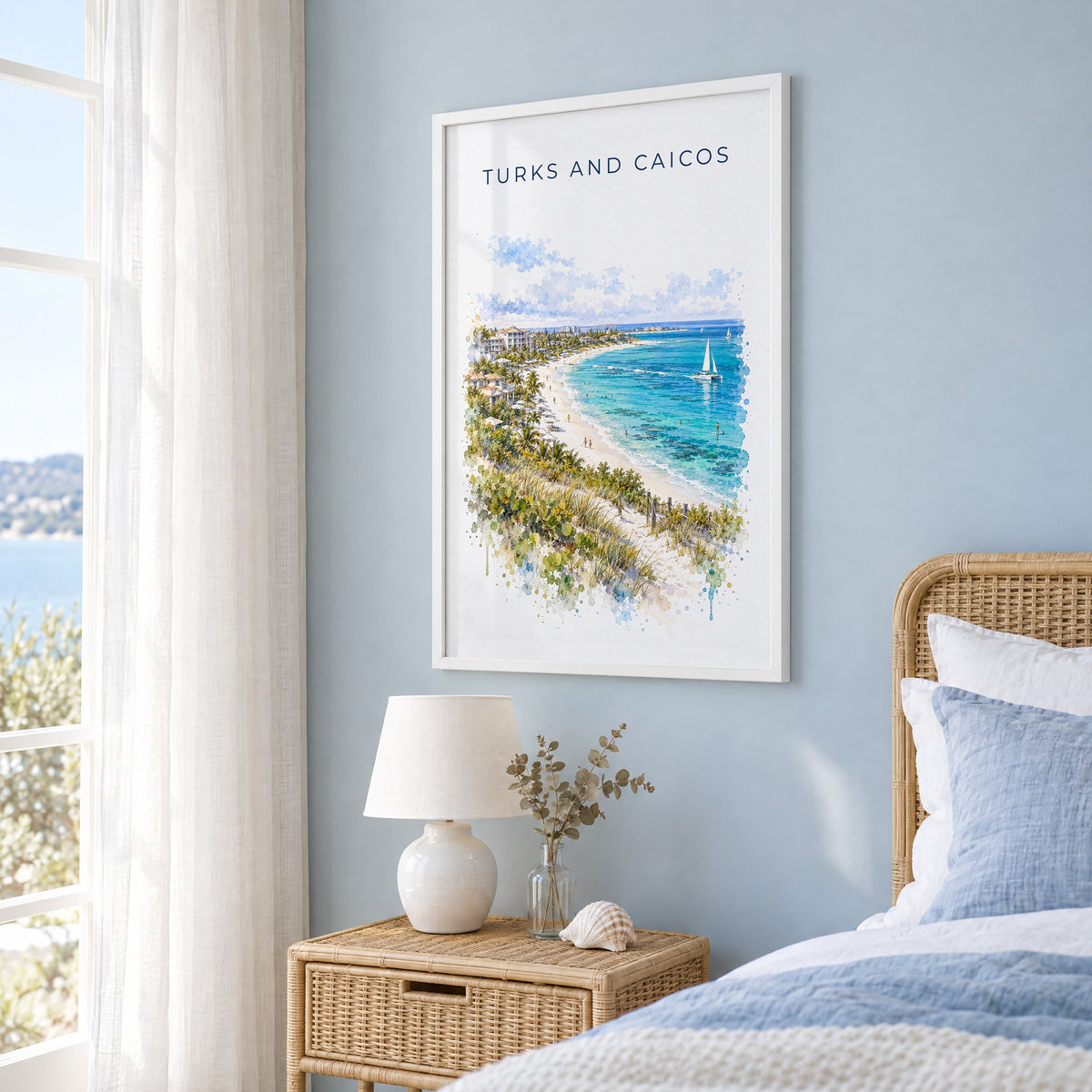 Turks and Caicos watercolor print in a white frame on a pale blue wall beside a rattan bed in a coastal bedroom