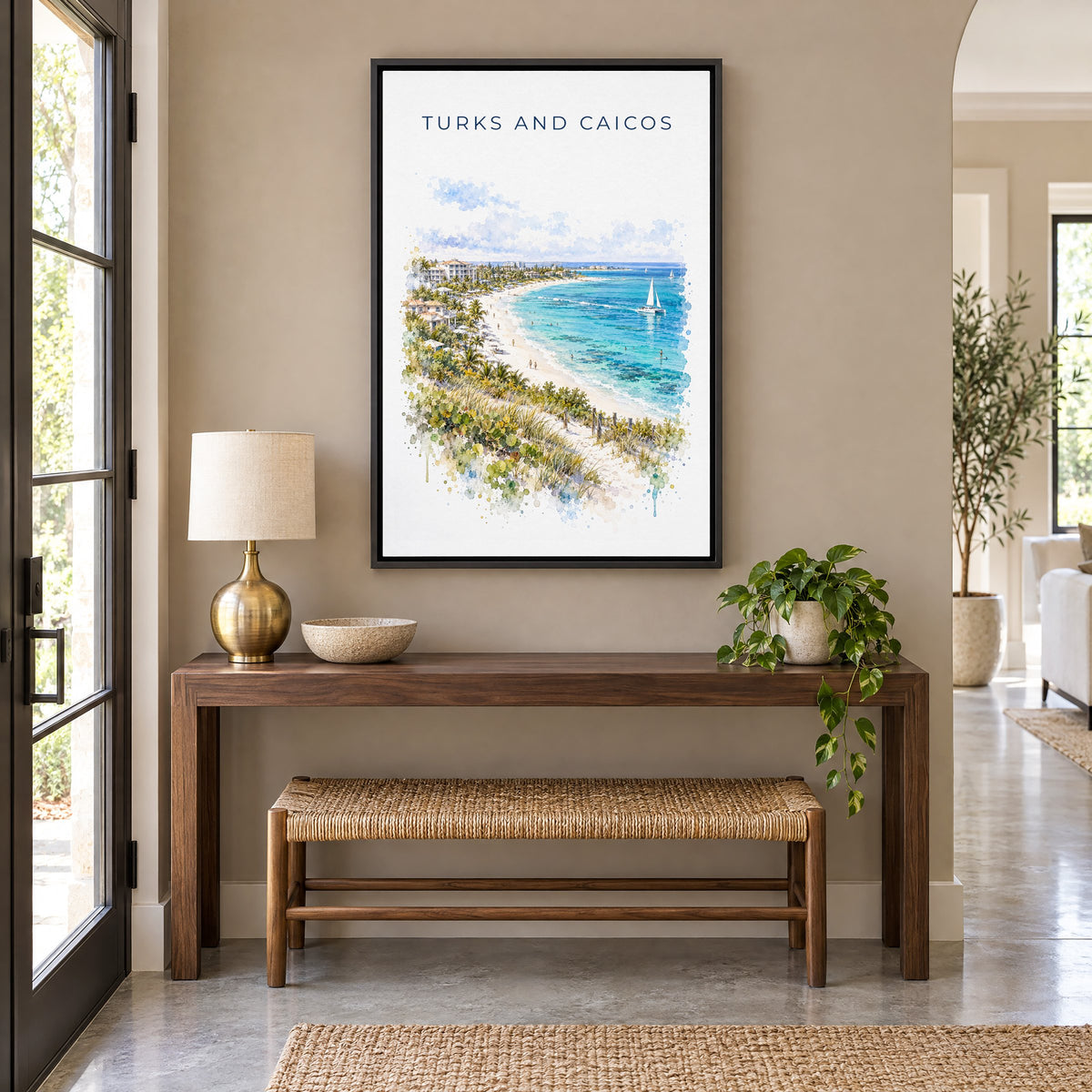 Turks and Caicos watercolor print as a black floater canvas above a walnut console and woven bench in an entryway
