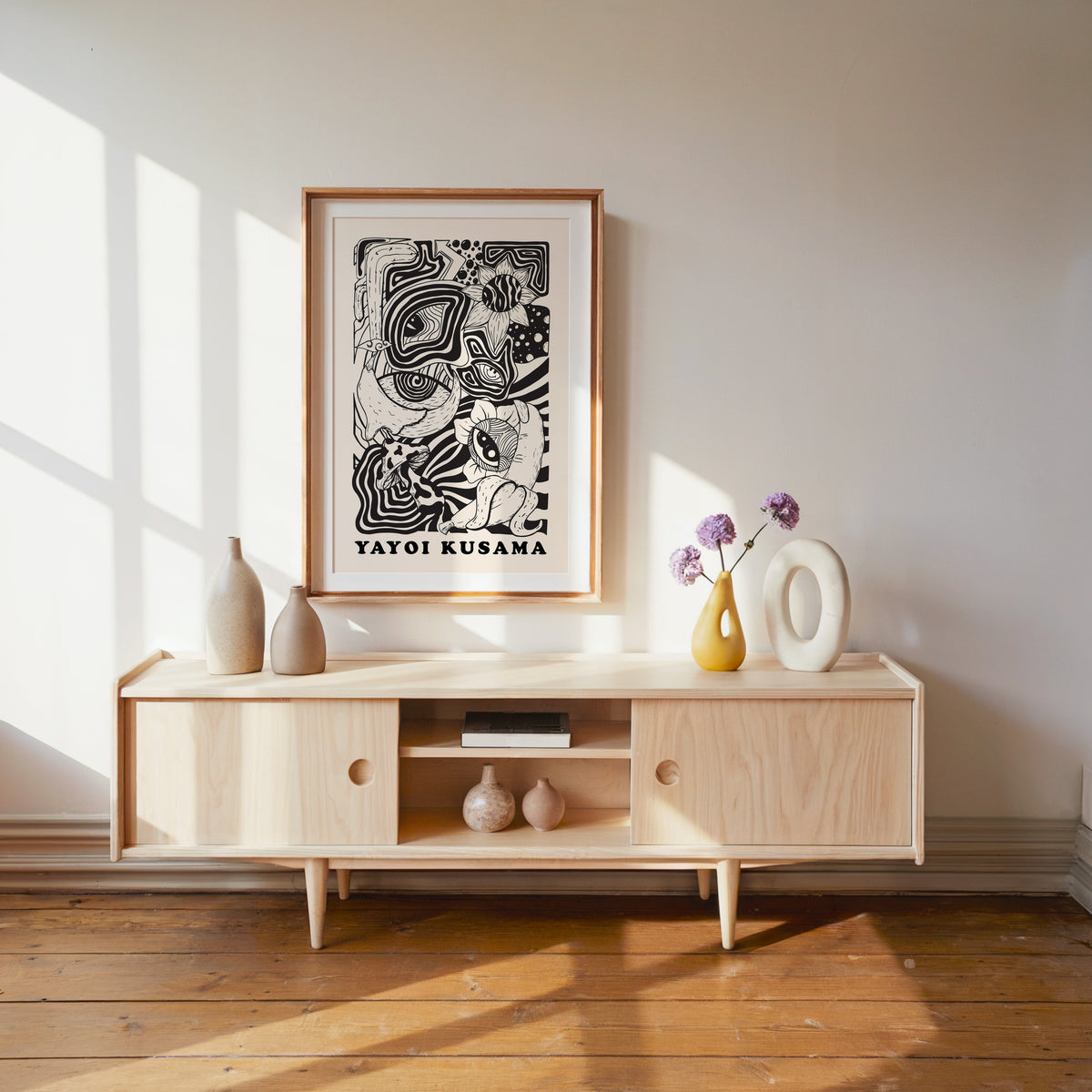 Yayoi Kusama inspired psychedelic eyes and mushroom print in a wood frame with white mat over a pale media console