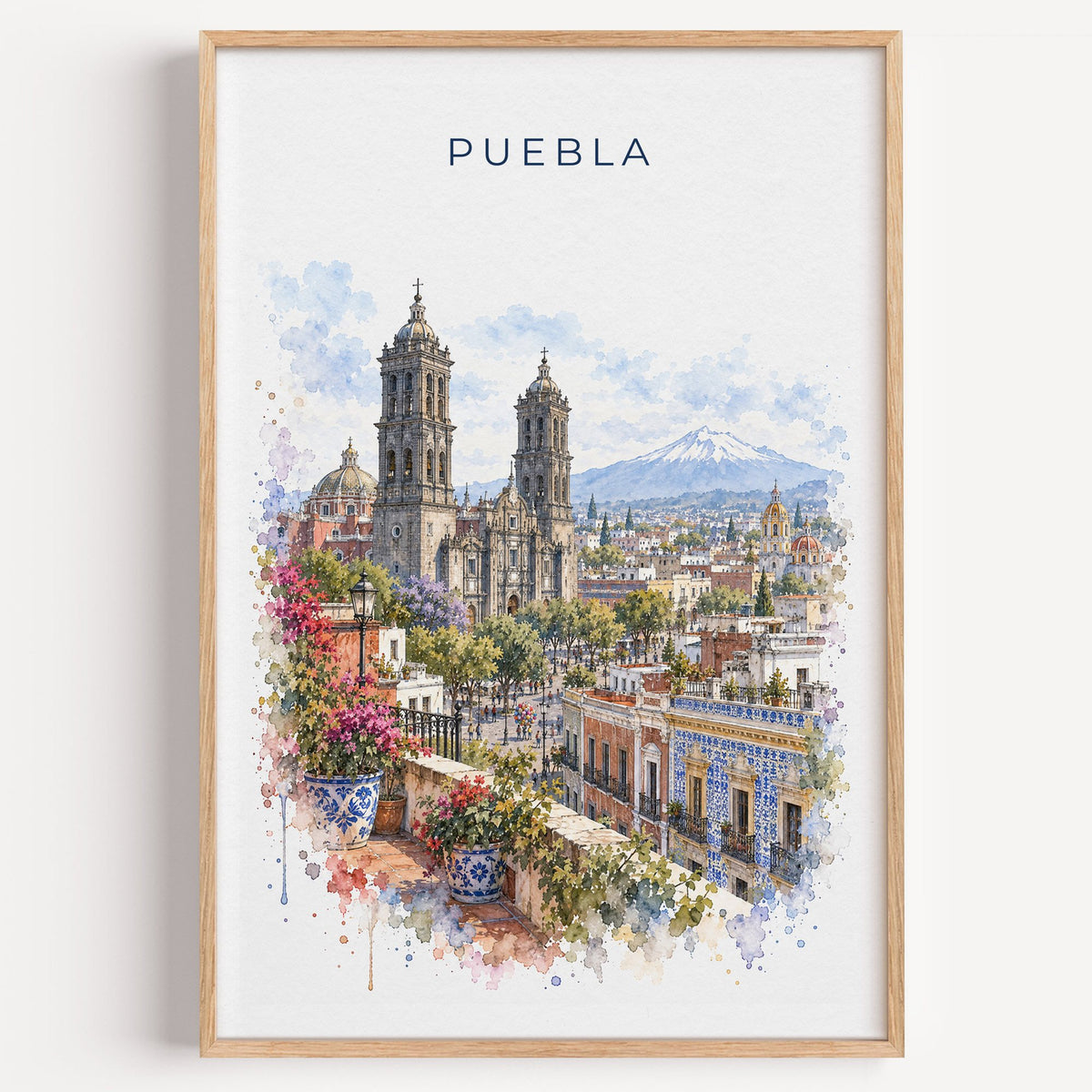 Puebla watercolor print in a light oak frame on a plain white wall