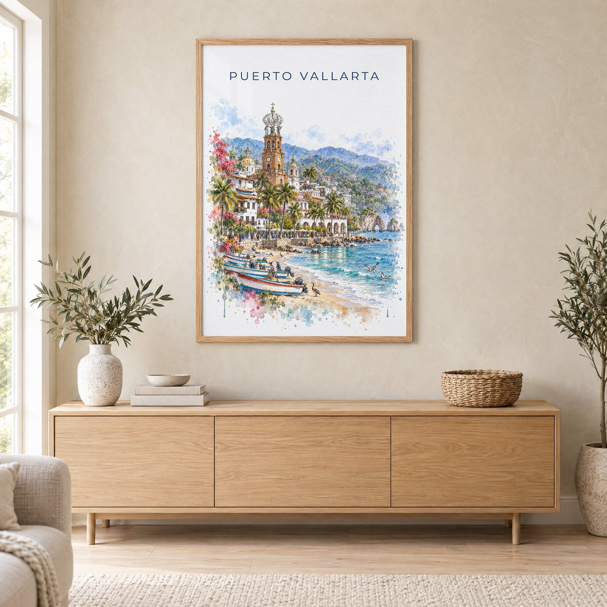 Puerto Vallarta watercolor print in an oak frame above a light wood sideboard in a Scandinavian living room