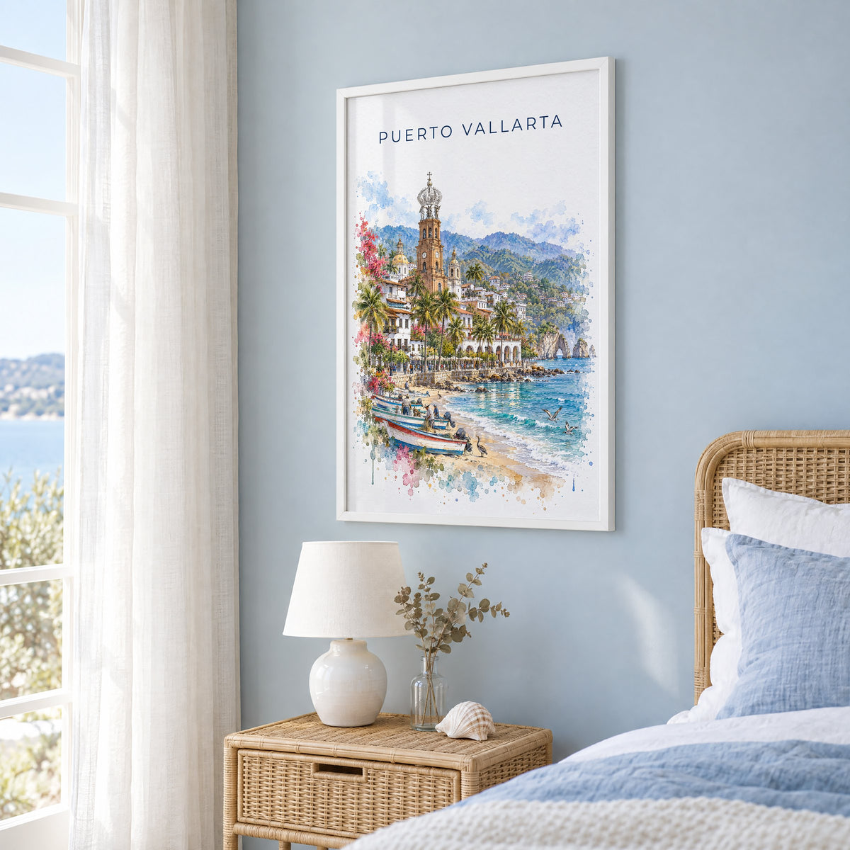 Puerto Vallarta watercolor print in a white frame on a pale blue wall beside a rattan bed in a coastal bedroom