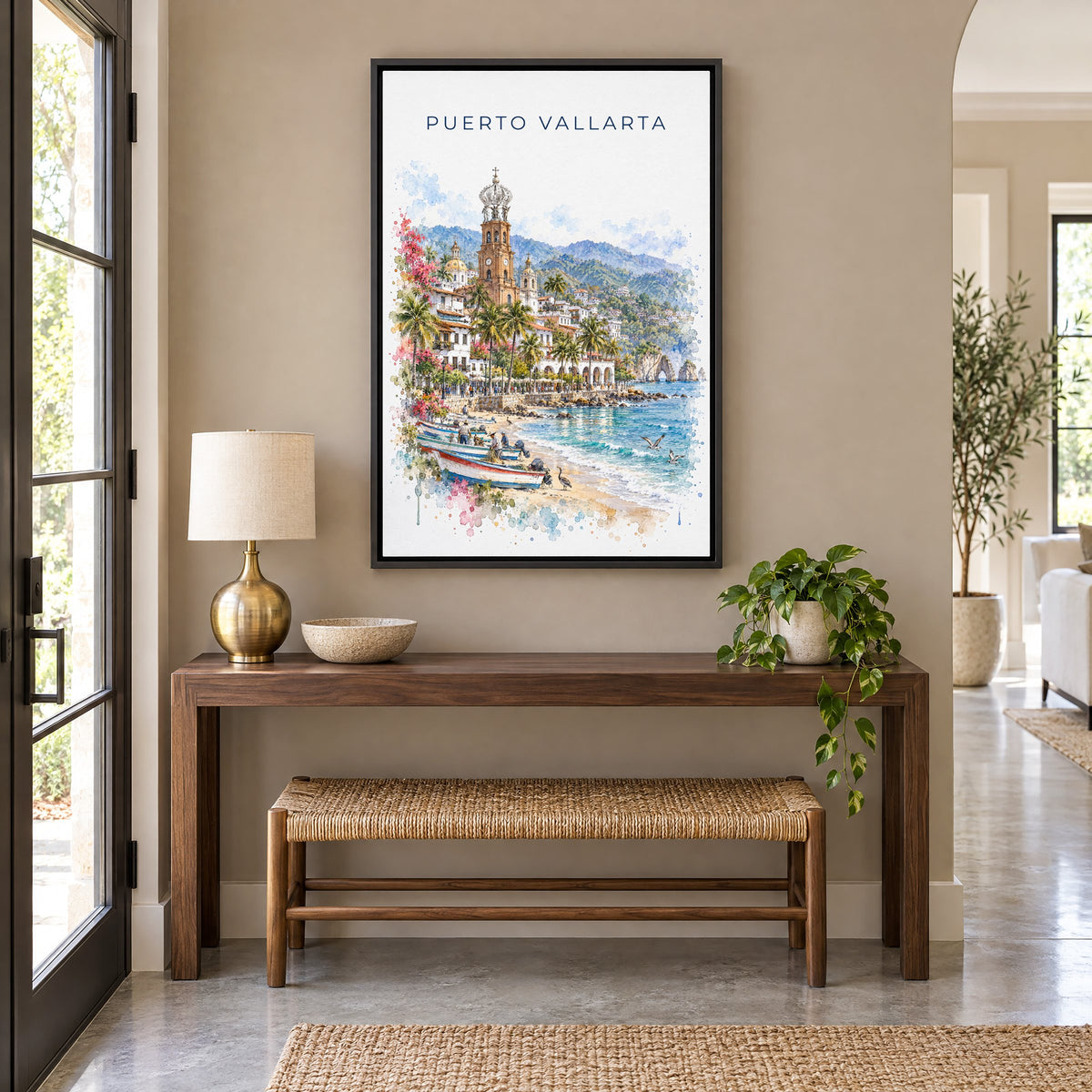 Puerto Vallarta watercolor print as a black floater canvas above a walnut console and woven bench in an entryway